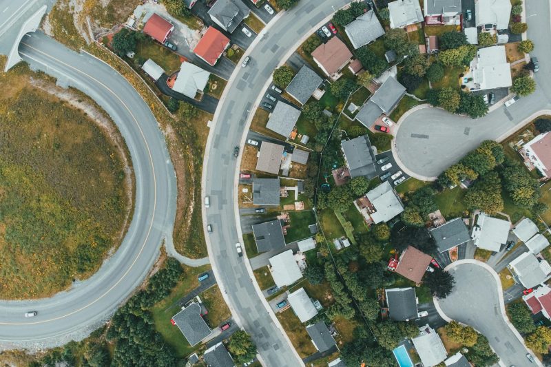 Aerial view of a suburban neighborhood with curved roads and 1779210070